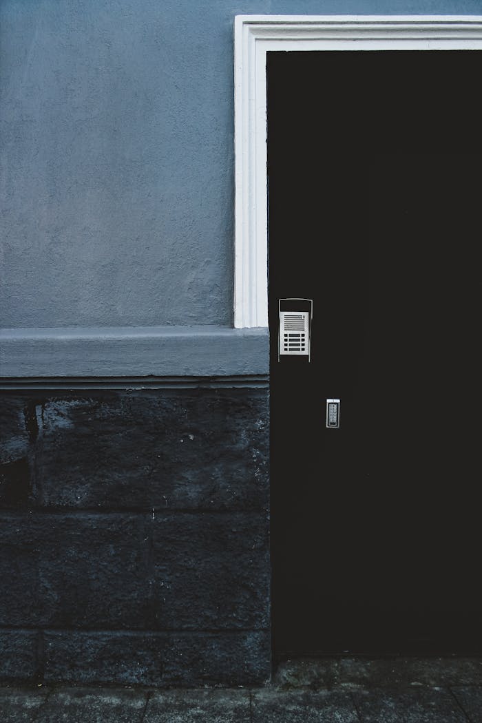 A contemporary dark door with a security keypad offers modern design and safety.